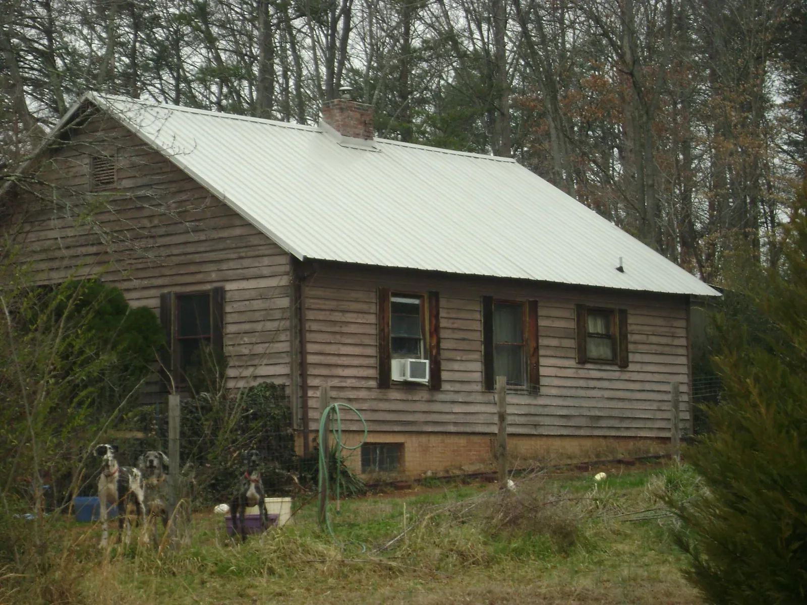White metal roof on an old wood sided farmhouse, from a Metal Roof Installation job in Cowiche